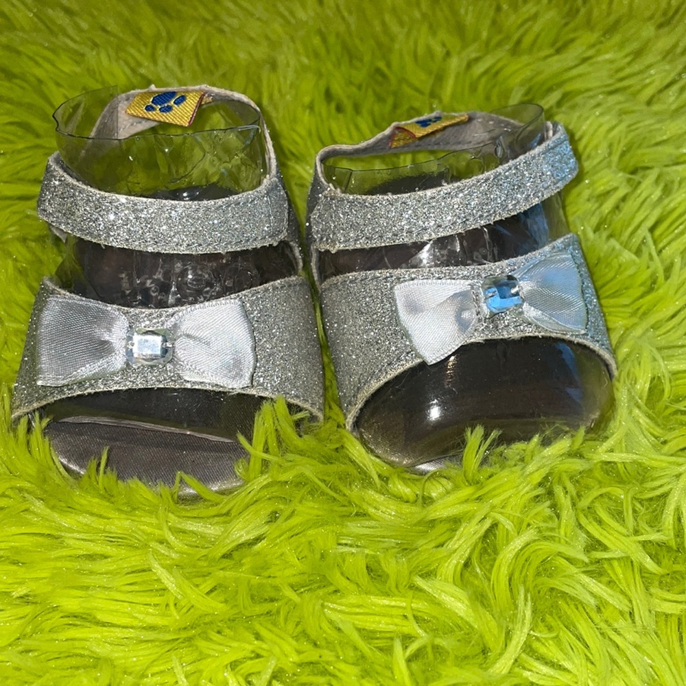Build A Bear shoe high heels have a silver-sparkle and cute bow with gem.